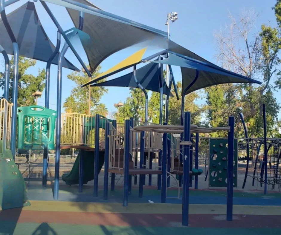Modern playground with blue and silver shade structures at Tarzana Recreation Center, providing a fun and safe outdoor space for children.